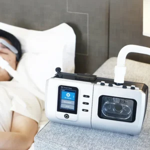 DS6 CPAP machine operating beside a sleeping user