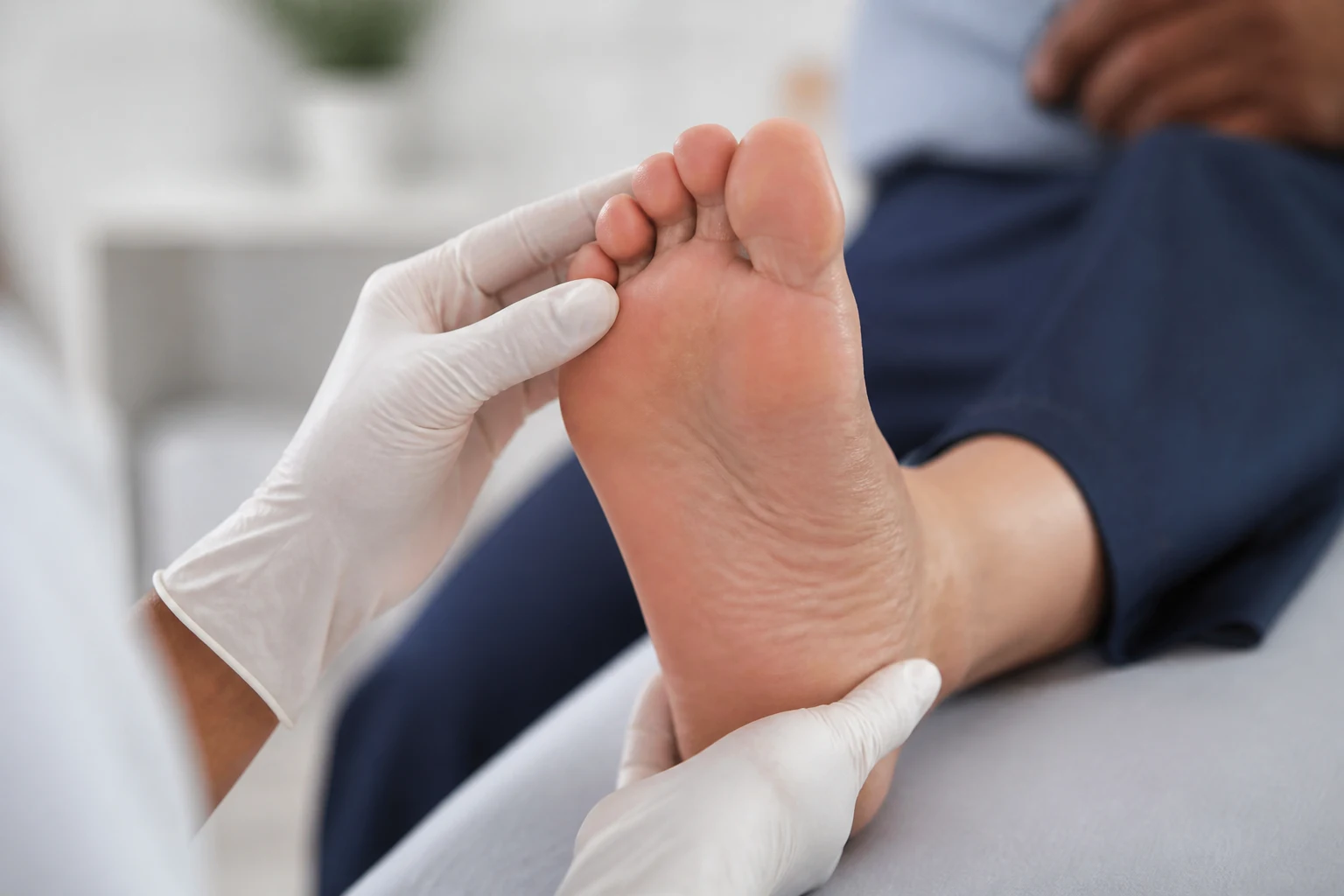 Examining the sole of a foot for skin changes after an EMS session
